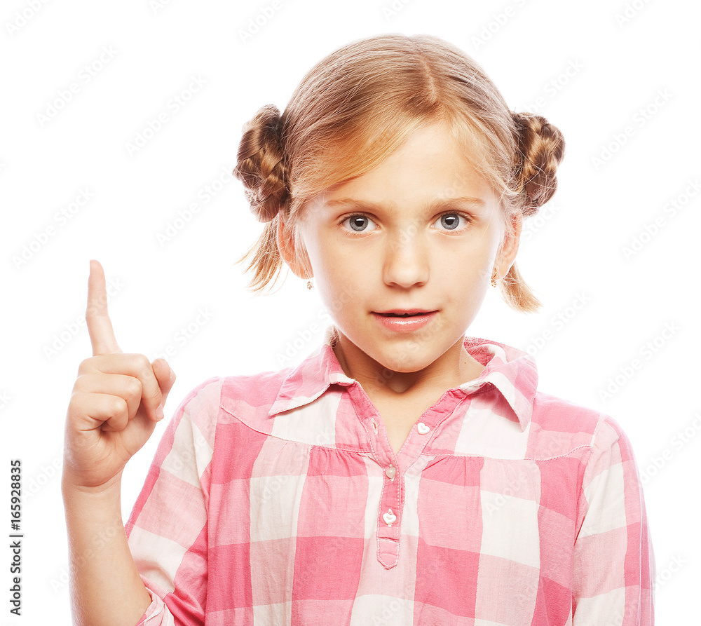 Pretty school girl pointing her index finger upwards in exciteme Pretty school girl pointing her index finger upwards in exciteme