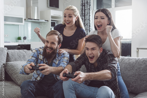 Group of friends having party together at home