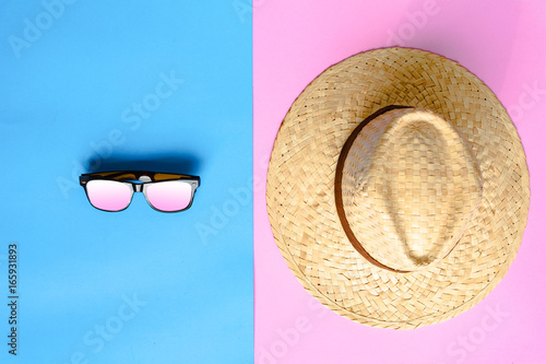 flat lay hat and sunglasses on colorful paper