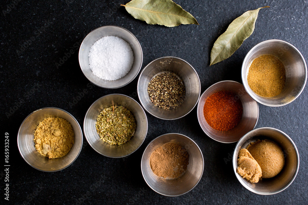 Assorted Indian spices in metal cups Assorted Indian spices in metal cups