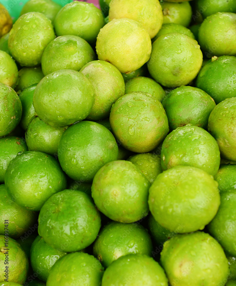 limes stacked up for sale on a market limes stacked up for sale on a market