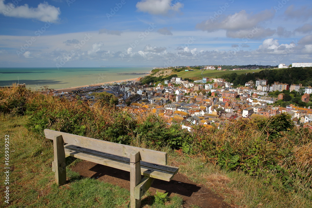 General view of Hastings old town from East Hill with a wooden bench in the foreground, Hastings, UK