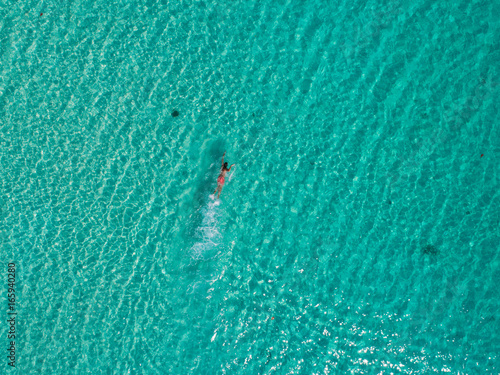 Man swimming in the amazingly blue ocean of Cambodia