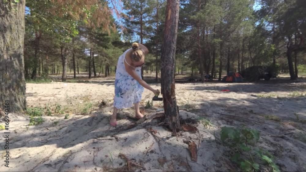 Wicked girl, chills her fervor about a dried tree. Slow motion Wicked girl, chills her fervor about a dried tree. Slow motion