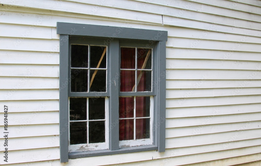 A window on the side of the house. A window on the side of the house.