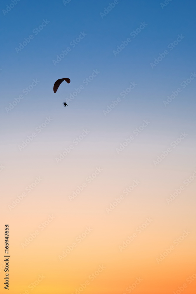 Paraglider in the sky at sunset