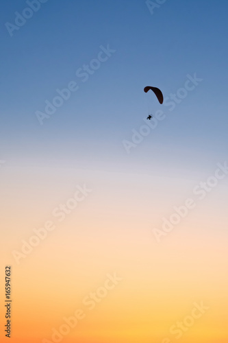 Paraglider in the sky at sunset