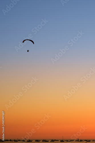 Paraglider in the sky at sunset © Pavel Korotkov