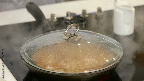 Stewing buckwheat porrige with minced meat in a frying pan photo