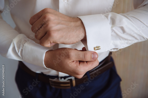 Groom hands with cufflinks. Elegant gentleman clother, white shirt