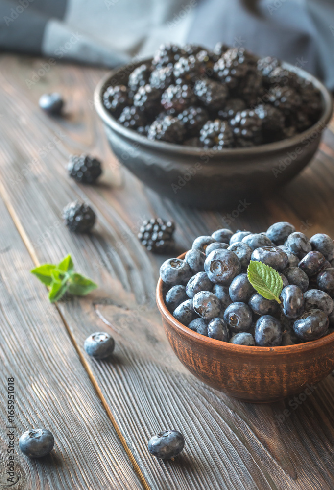Bowls of blackberries and blueberries Bowls of blackberries and blueberries