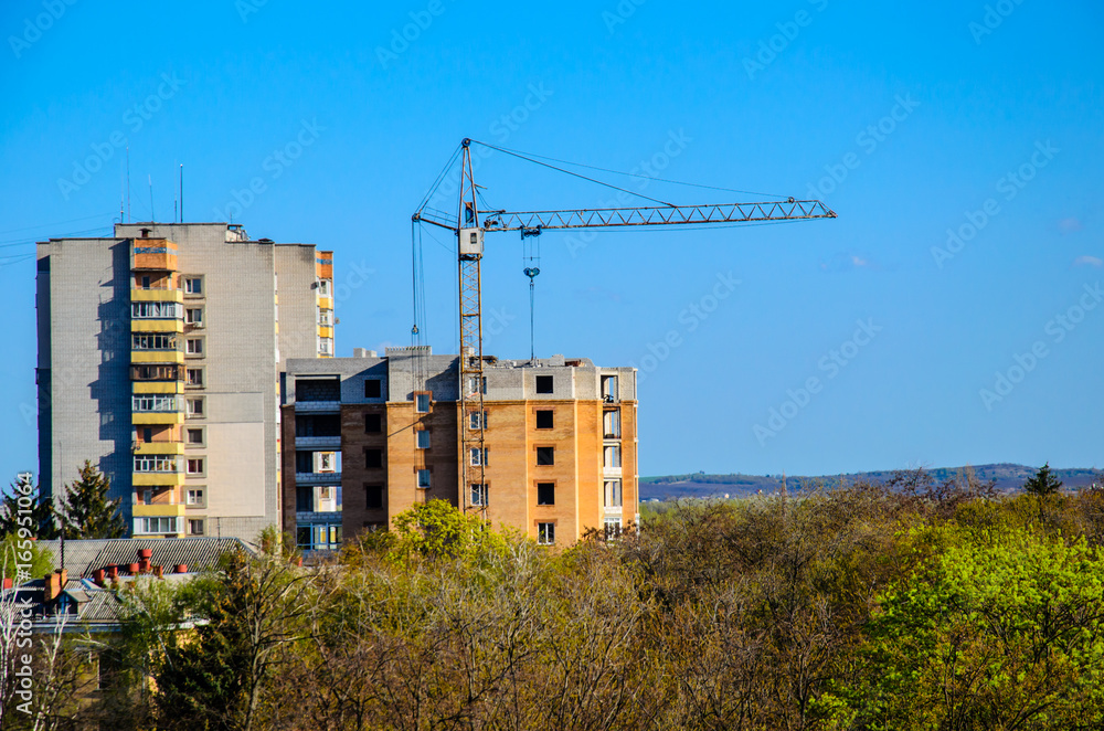 High construction crane against blue sky High construction crane against blue sky