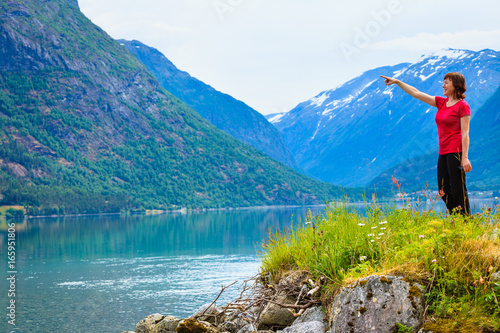 Tourist woman enjoying fjord view in Norway