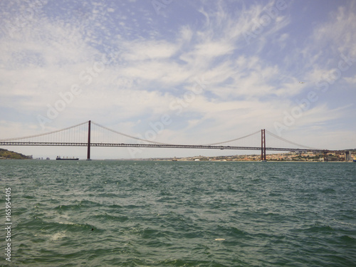 The bridge 25th of April viewed from the other side of river Tagus - Cacilhas, Almada