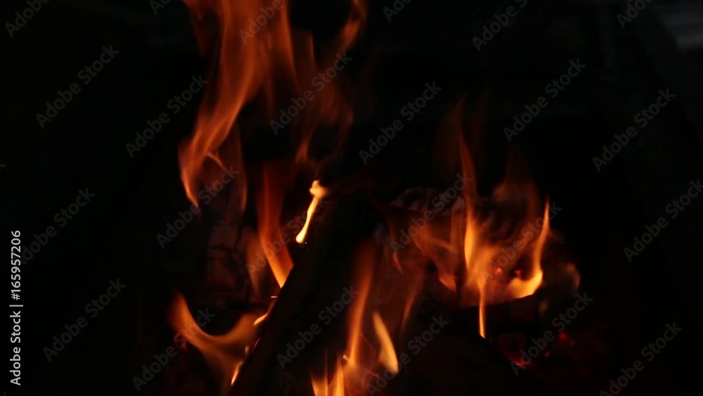 Closeup of burning bright fire in fireplace in darkness. Real time full hd video footage. Closeup of burning bright fire in fireplace in darkness. Real time full hd video footage.
