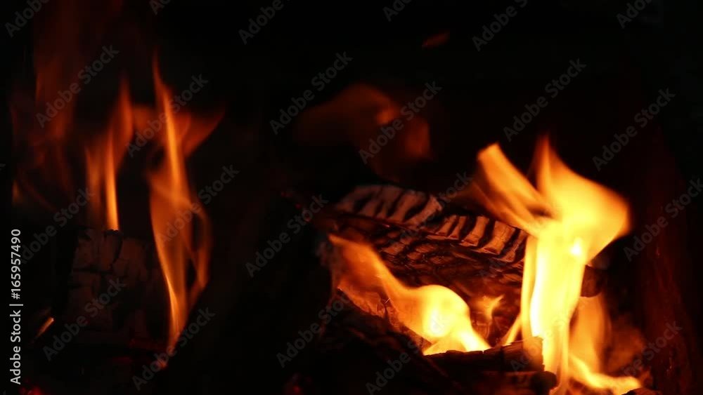 Closeup of bright burning fire in fireplace in darkness. Real time full hd video footage. Closeup of bright burning fire in fireplace in darkness. Real time full hd video footage.