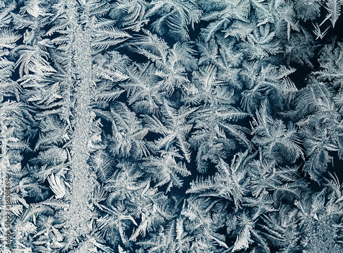 beautiful ornate festive frosty pattern on glass winter window