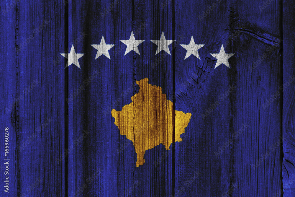 Fototapeta premium Kosovo flag painted on wooden wall for background