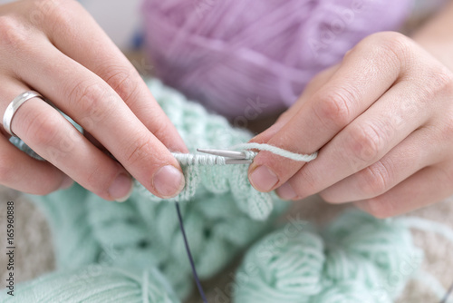 Hands of a master seamstress at work, knitting