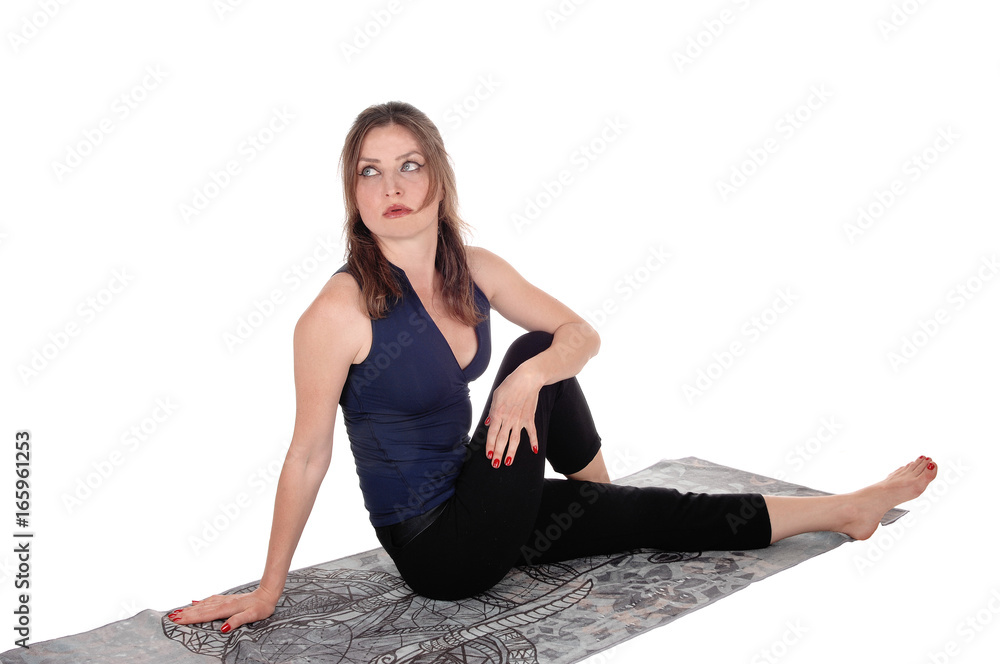 Exercising woman sitting on floor, resting