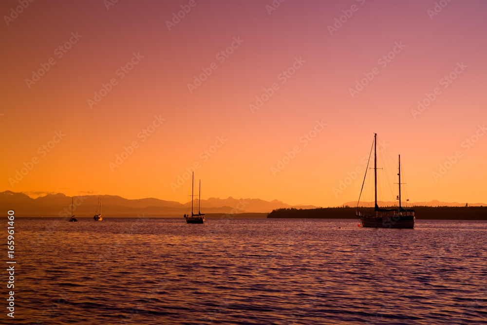 Sailboats at sunset on the west coast of British Columbia 
