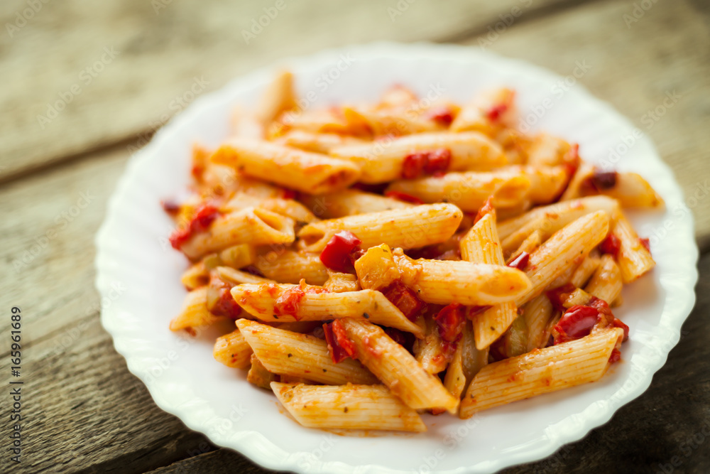 Plate of pasta with paprika and zucchini Plate of pasta with paprika and zucchini