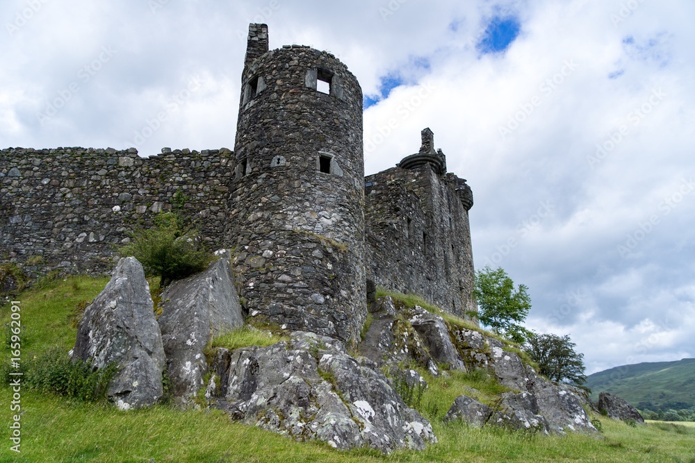 Castle from below cloudy sky rocks ruins