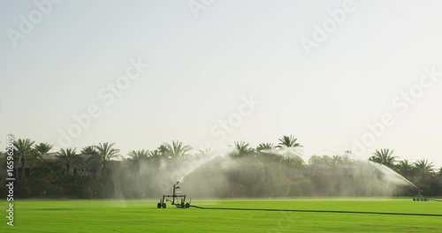 Sprinkler system on field, slow motion