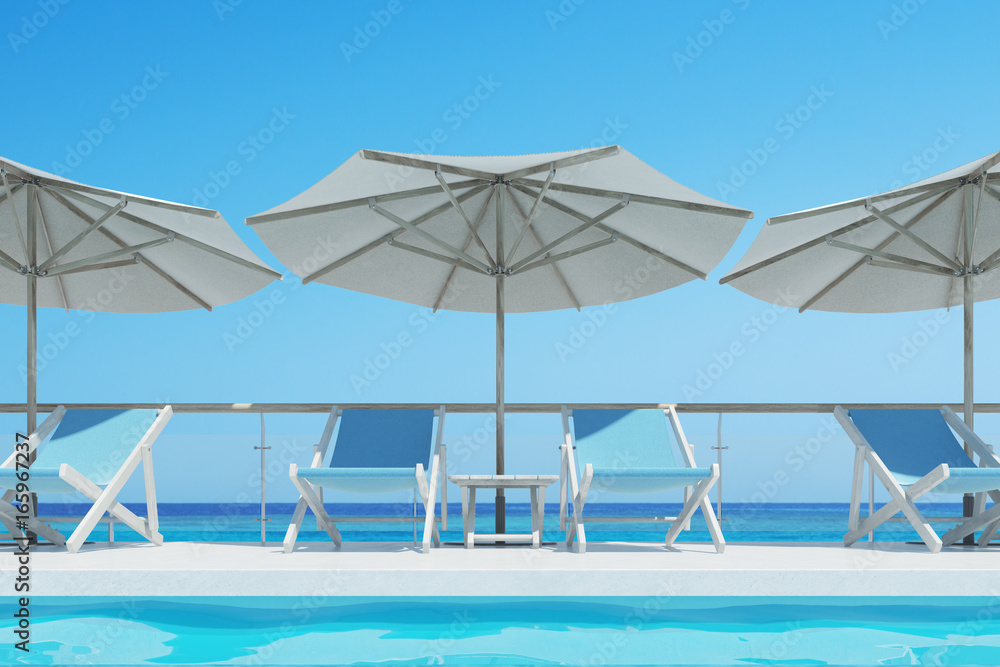 Fototapeta premium Blue deck chairs, umbrellas, blue sky