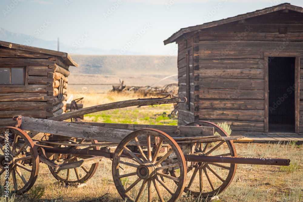 Fototapeta premium Abstract of Vintage Antique Wood Wagon and Log Cabins.