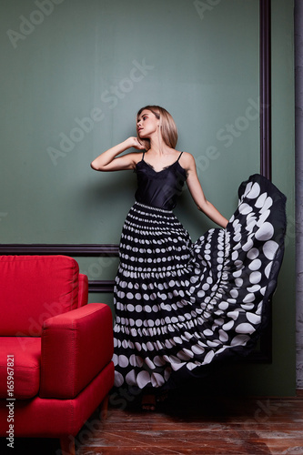 Beautiful sexy blond yang woman lady pretty wear long dress party evener meeting date celebrity fashion style designer show performance elegant dancer character sit on armchair furniture interior photo