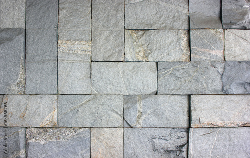 Stone texture of granite wall for creative background. Dark monolithic stones
