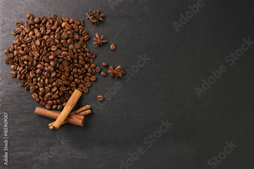 Εκτύπωση καμβά Cinnamon sticks with anise star flavoring and arabica coffee beans on dark stone background with copy space