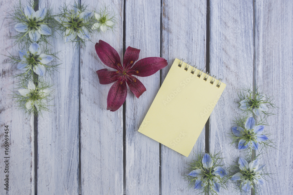 A note on a wooden surface framed by flowers 6 A note on a wooden surface framed by flowers 6