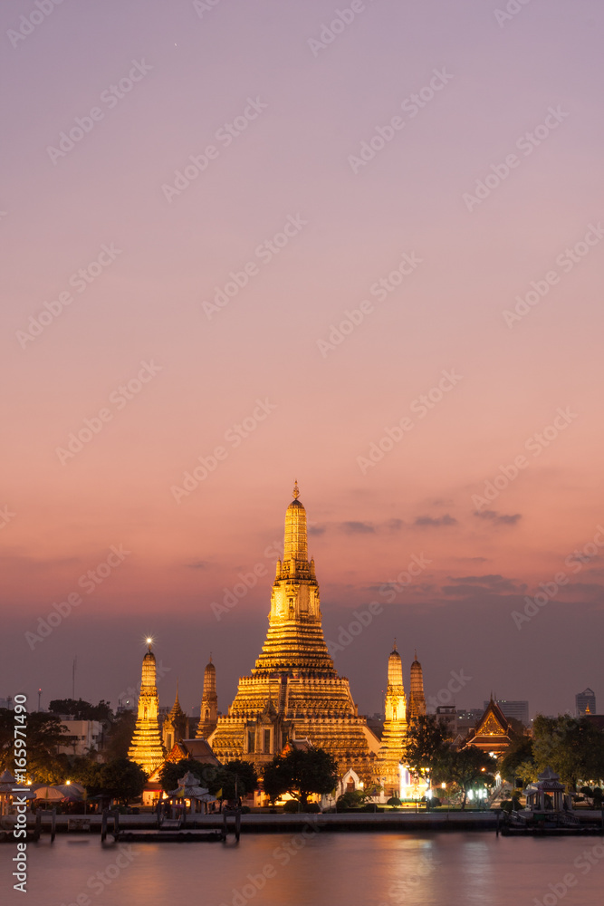 Wat Arun, located along the Chao Phraya River in Bangkok at sunset.
