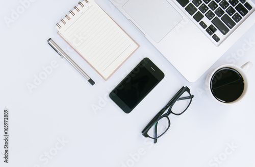 White office desk table with a lot of things on it. Top view with copy space.