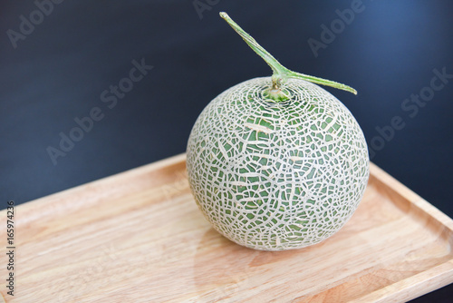 Green Cantaloupe Melon Isolated on Wooden Board