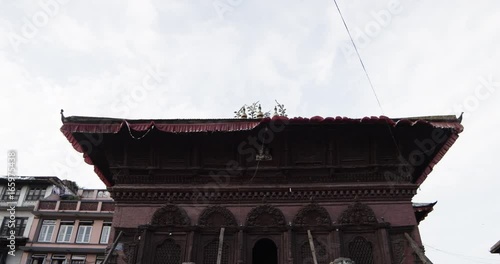 Tilt down, lion statues in front of abandoned temple