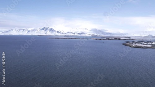 Waves by coastal landscape, aerial