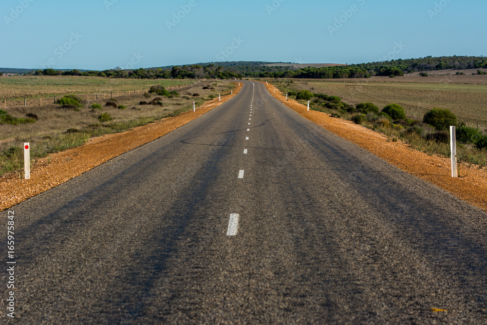 landscape scene above road. asphalt road through the dessert land field. landscape scene above road. asphalt road through the dessert land field.