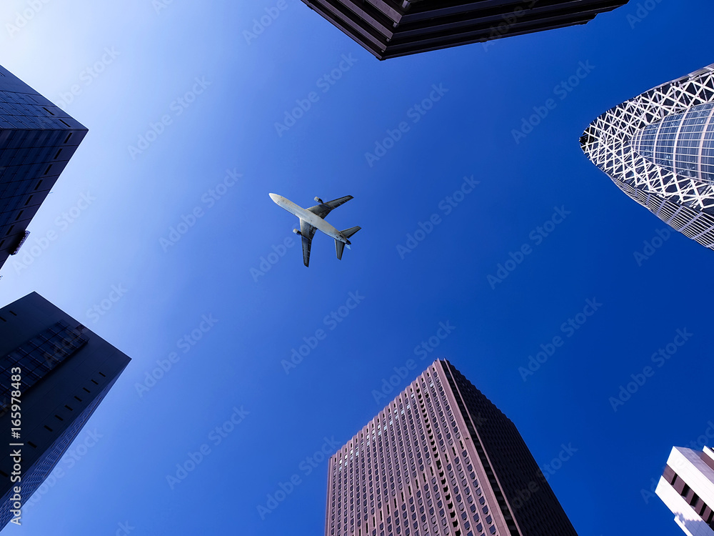 airplane flying over buildings