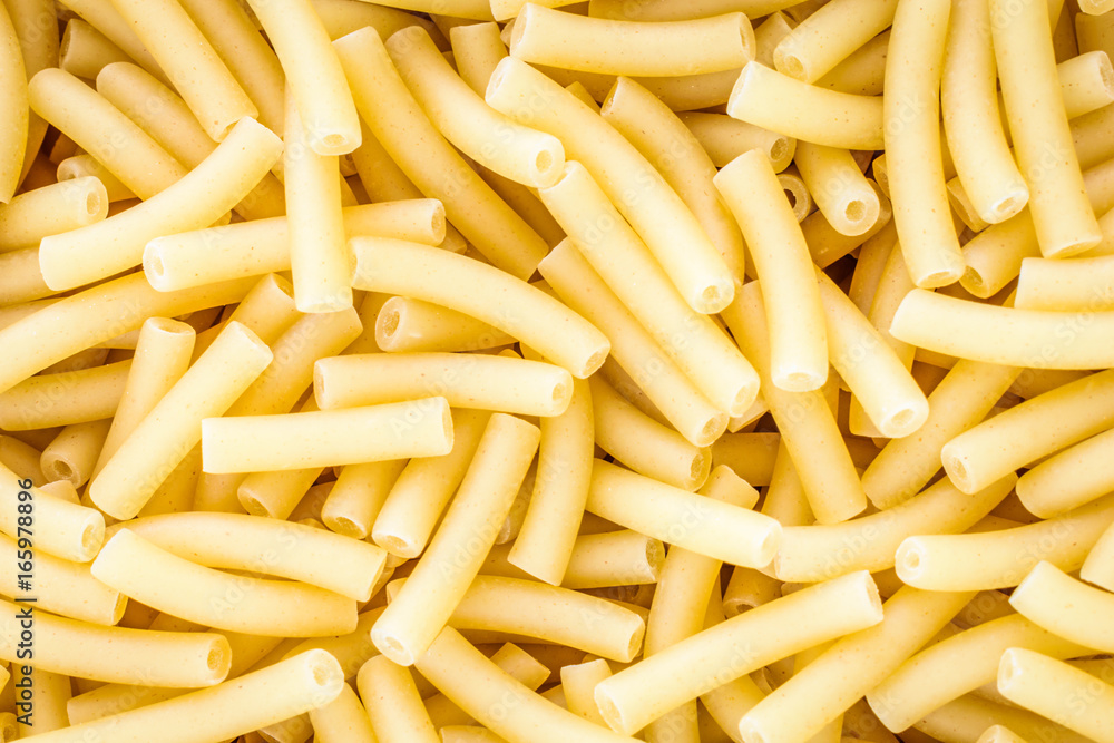 Close up full frame of dry uncooked macaroni. Food Background. Close up full frame of dry uncooked macaroni. Food Background.