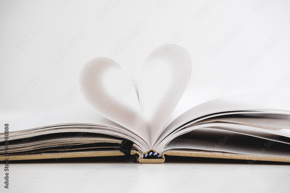 Heart shape on opened notebook page, on white background Heart shape on opened notebook page, on white background