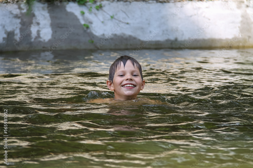Smiling boy swimming in lake Smiling boy swimming in lake