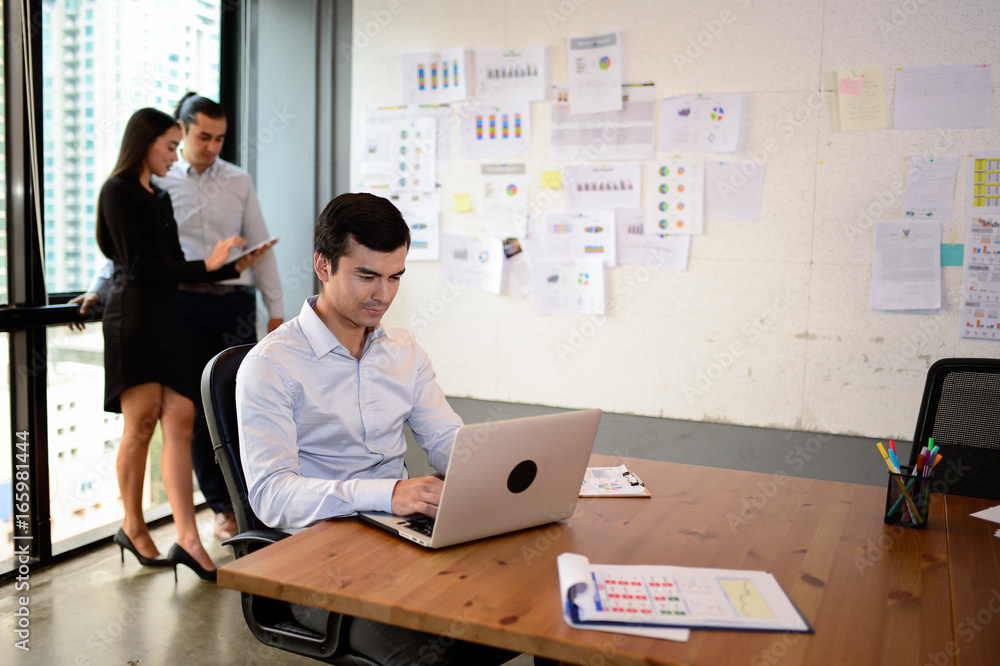 Handsome business man sit on the chair and work with laptop at the office, successful concept Handsome business man sit on the chair and work with laptop at the office, successful concept