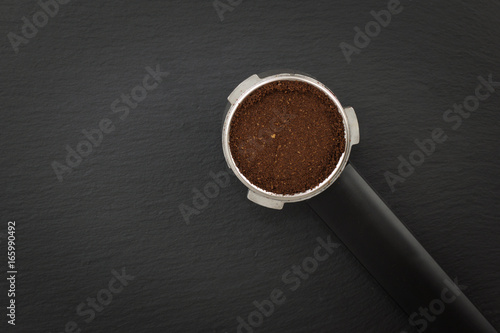 Espresso filter holder for coffee machine  on Black background with copy space photo