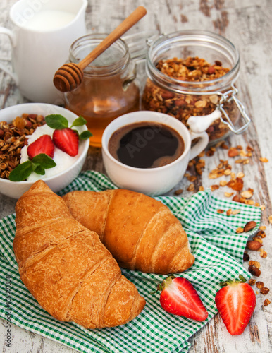Croissant, coffee, granola  and strawberry