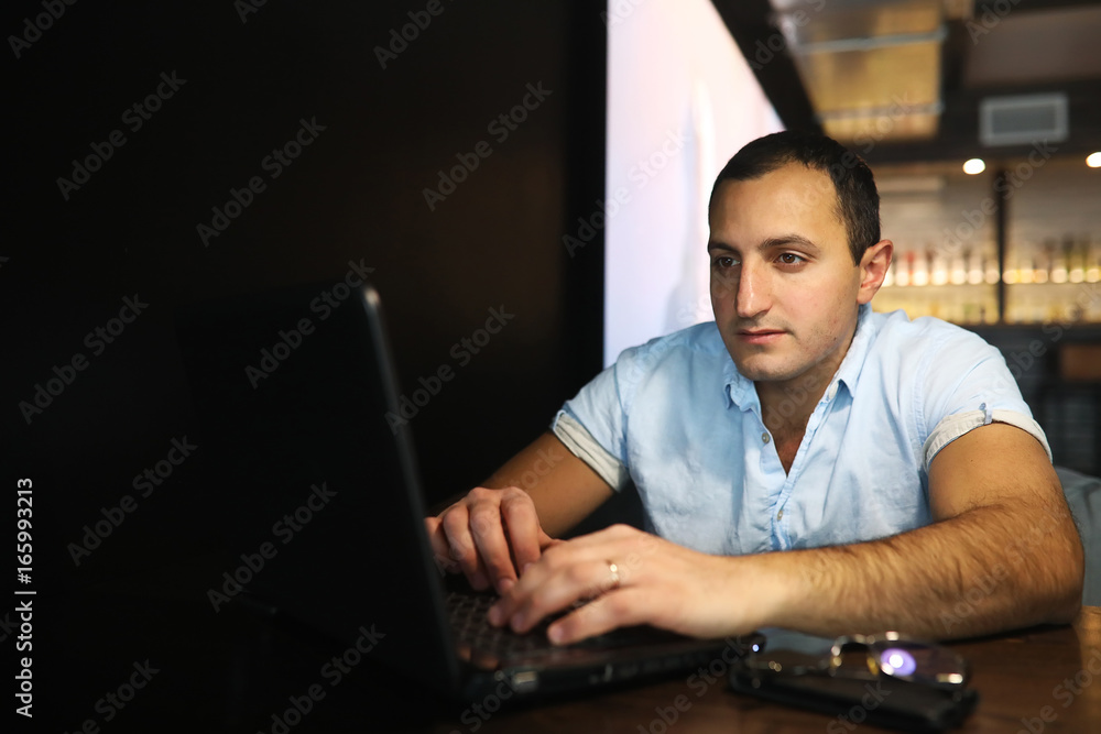 Armenian handsome man working behind laptop Armenian handsome man working behind laptop