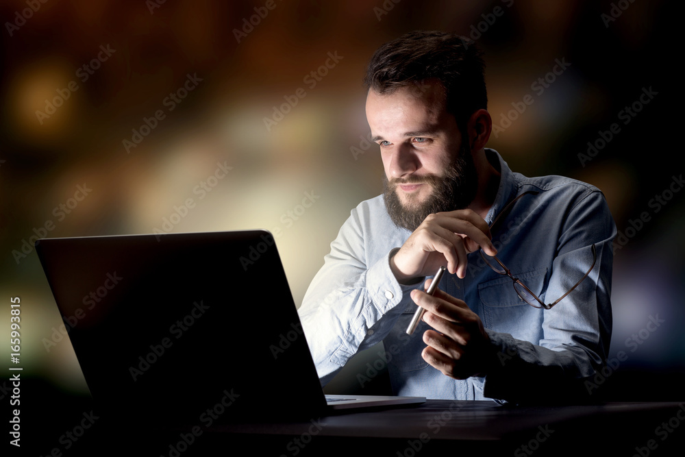 Businessman in the office at night Businessman in the office at night