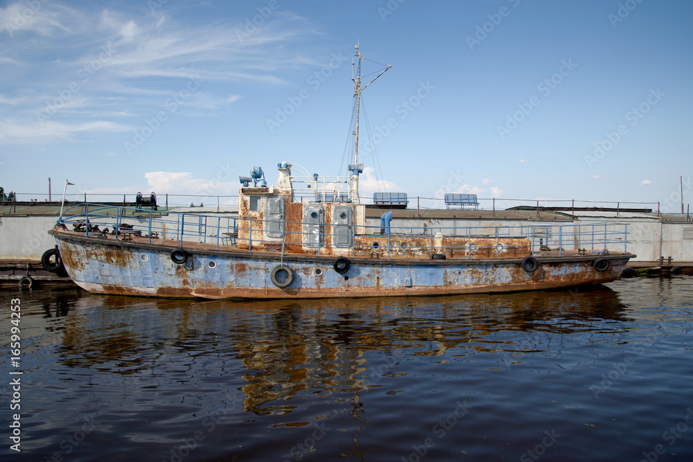 An old rusty ship in the pier on the Volga river.